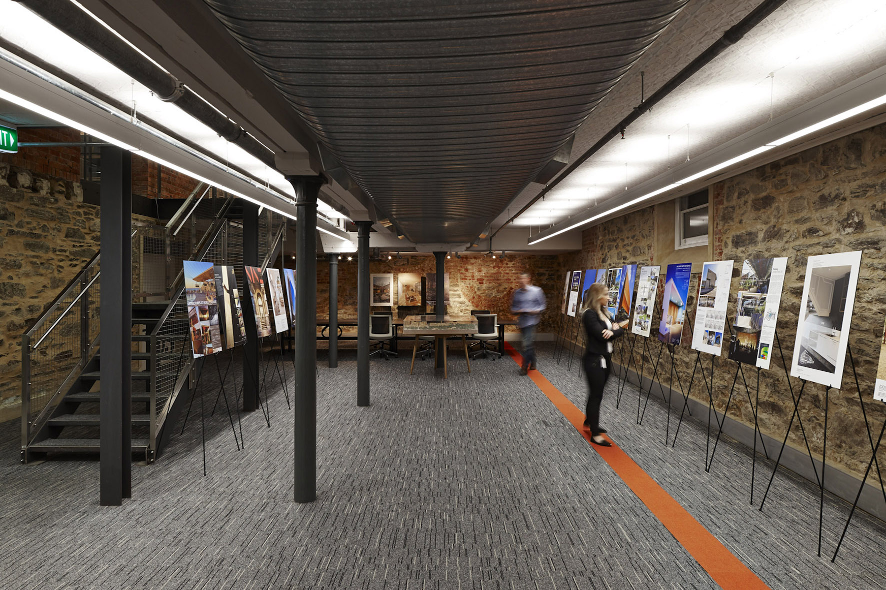Visitor looking at posters displayed in the lower ground gallery space